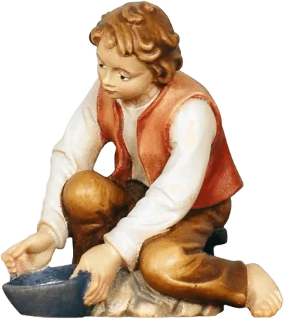 Hand-carved wooden figure of a boy milking, seated with a bowl, painted in natural colors