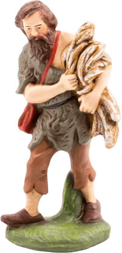Hand-painted papier-mâché shepherd figure holding straw, wearing rustic clothing and red shoulder bag