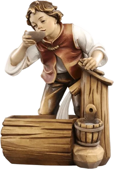 Hand-carved wooden figure of a boy drinking from a bowl by a wooden well, hand-painted in natural tones